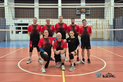 Drożyna Karpackiego Oddziału SG ubrana w czerwone stroje siatkarskie na tle wnętrza hali sportowej