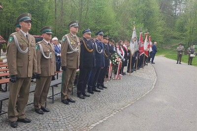 uczestnicy zebrani podczas uroczystości. na pierwszym planie stoją funkcjonariusze straży granicznej, dalej stoją przedstawiciele innych służb mundurowych między innymi straży pożarnej, policji  i straży miejskiej, następnie stoją poczty sztandarowe przybyłe na uroczystość.