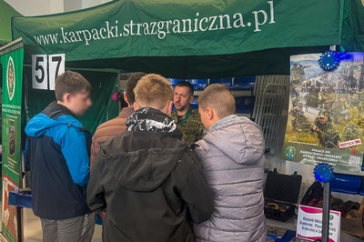 uczniowie stoją przy stoisku karpackiego oddziału straży granicznej podczas targów edukacyjnych