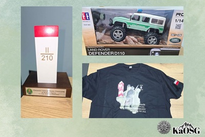 Fanty przekazane na licytację : samochodzik SG zdalnie kierowany , okolicznościowa koszulka Straży Granicznej, słupek graniczny